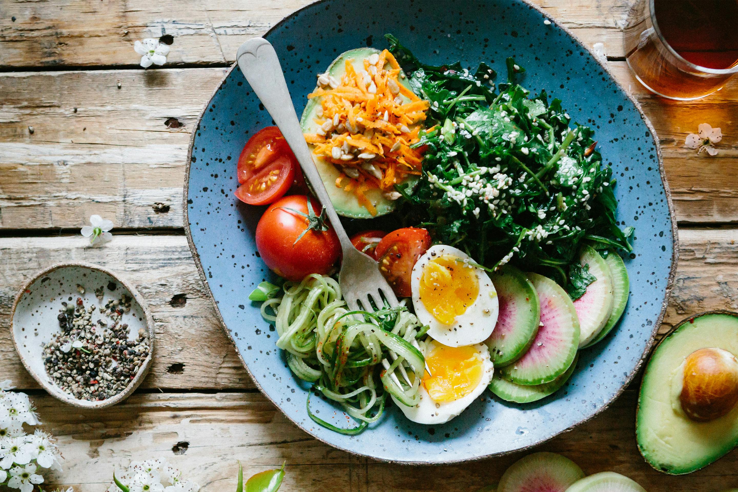 Paleo Bowl mit frischem Gemüse, gekochtem Ei und Avocado
